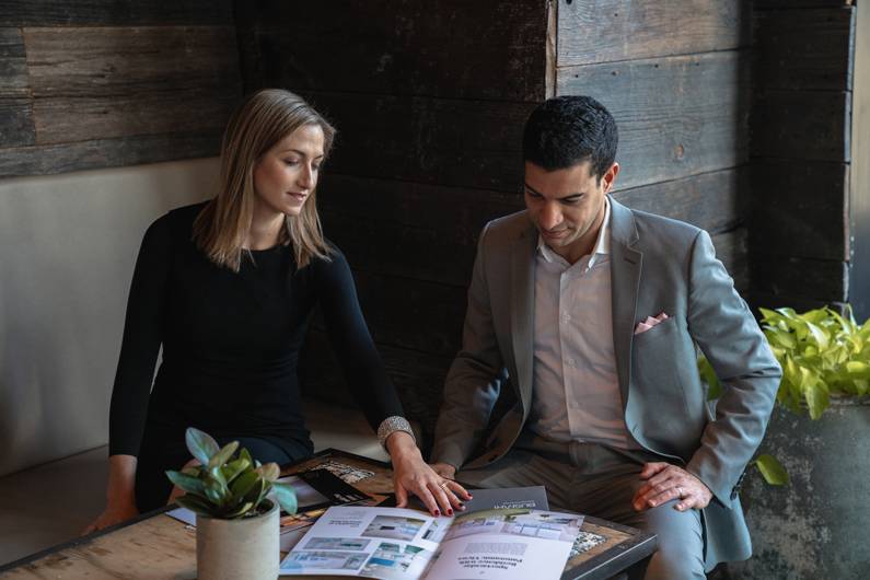 Brookline Real estate professionals Elad and Mara Bushari posing in a business lunch setting