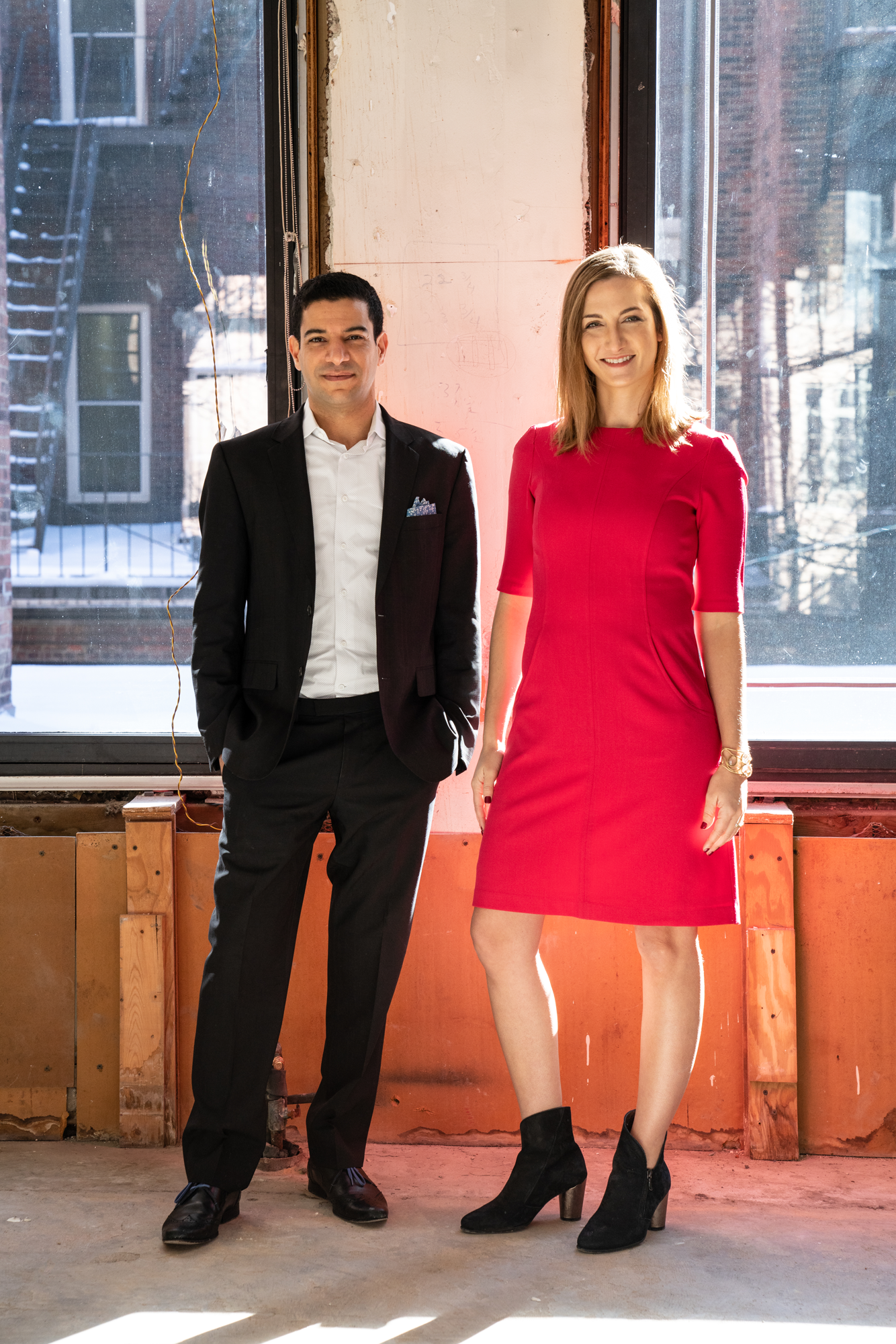 Brookline Real estate professionals Elad and Mara Bushari posing in a construction zone setting