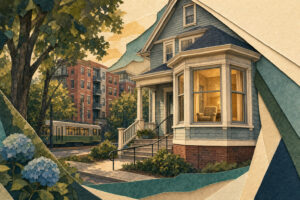 Blue craftsman house with bay window and steps, greenery in front; a streetcar and brick apartment building in the background.